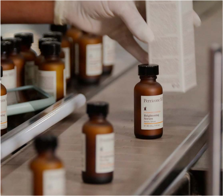 Bottles of Perricone MD Brightening Serums being checked in a lab environment