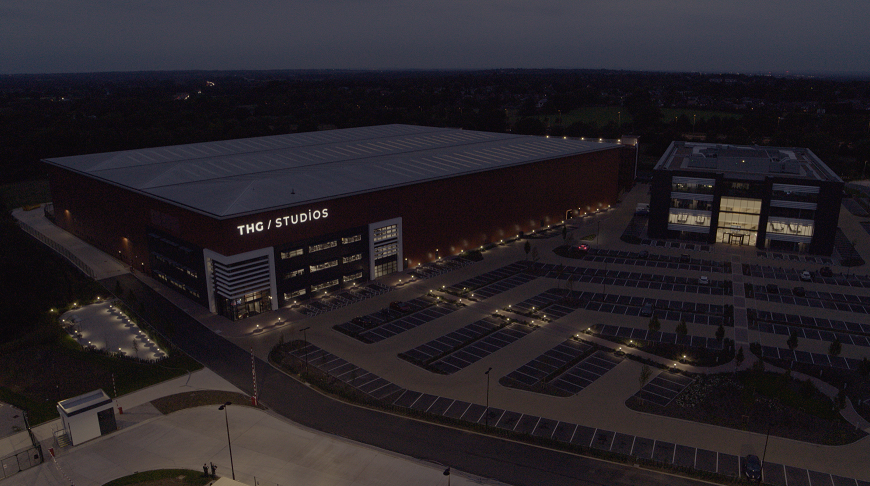 THG Studios CGI image at night with lights on the car park and in the offices