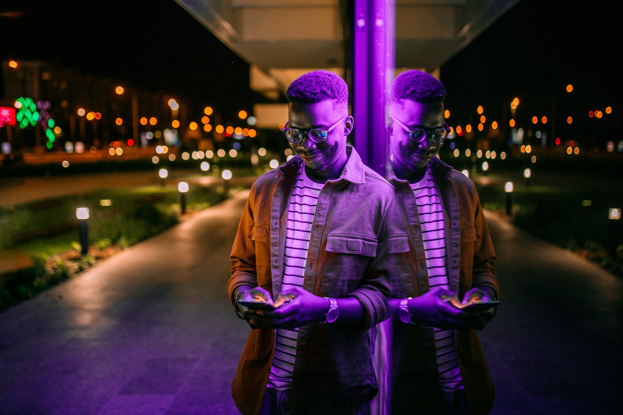 Man with phone in purple light